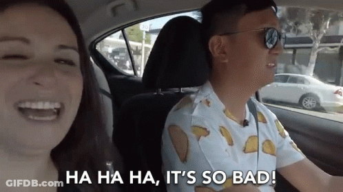 Man And Woman Laughing In Car With Tacos Shirt GIF