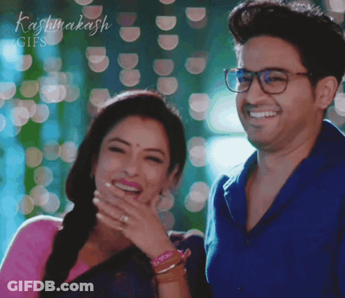 Man And Woman Laughing In Front Of Kashmakash Sign GIF