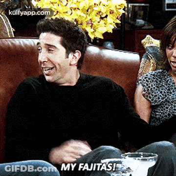 Man And Woman Laughing On Couch Saying My Fajitas GIF