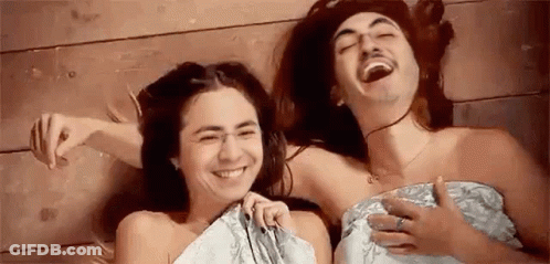 Man And Woman Laughing On Floor Wrapped In Towel GIF