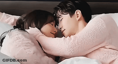 Man And Woman Laying In Bed Hugging GIF