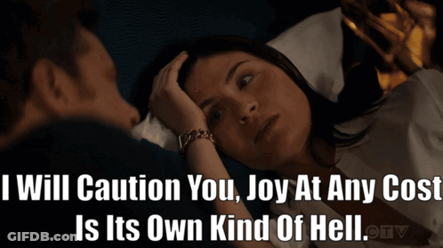 Man And Woman Laying In Bed With Caption I Will Caution You Joy At Any Cost GIF