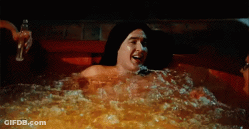 Man And Woman Laying In Hot Tub At Night GIF