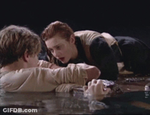 Man And Woman Laying In Water Looking At Each Other GIF