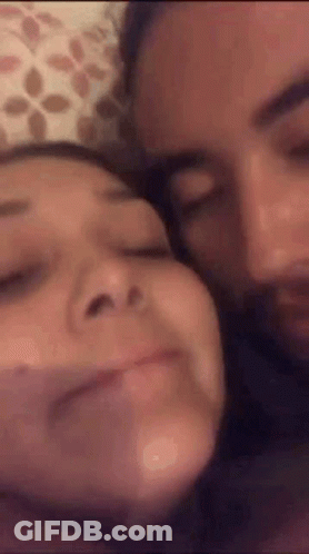 Man And Woman Laying On Bed Making Funny Faces GIF