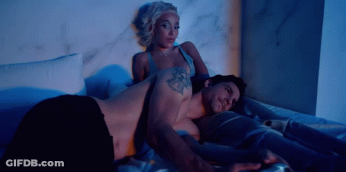 Man And Woman Laying On Bed Man With Arm Tattoo GIF