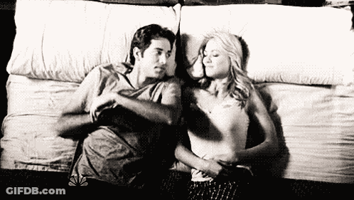 Man And Woman Laying On Bed GIF