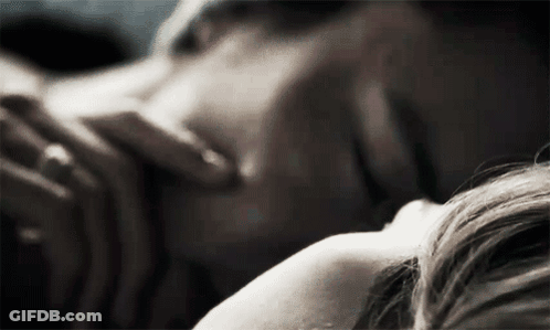 Man And Woman Laying On Bed Woman Touching His Neck GIF