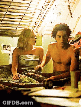 Man And Woman Laying On Bed Woman Wrapped In Blanket GIF