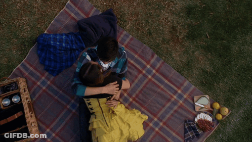 Man And Woman Laying On Blanket GIF