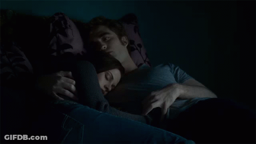Man And Woman Laying On Couch In Dark GIF