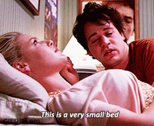 Man And Woman Laying On Small Bed Saying This Is A Very Small Bed GIF