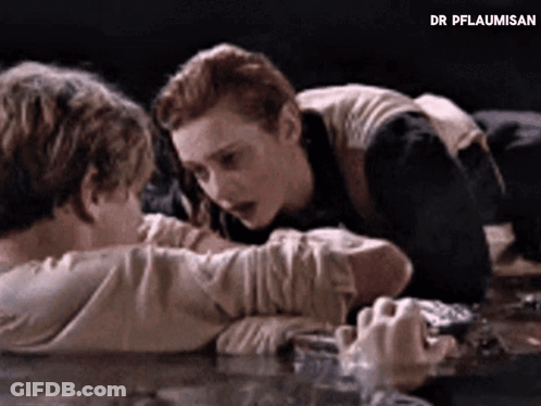Man And Woman Laying On Table With Dr Pflaumisan GIF