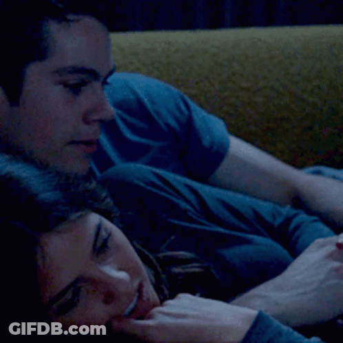 Man And Woman Laying On Yellow Couch GIF