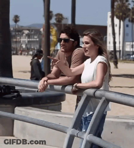 Man And Woman Leaning On Railing GIF