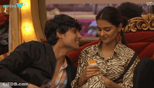 Man And Woman Looking At Each Other Before TV GIF