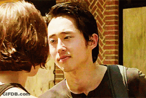 Man And Woman Looking At Each Other By Brick Wall GIF