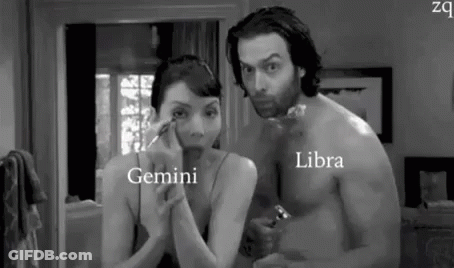Man And Woman Looking At Each Other In Bathroom Mirror GIF