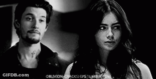 Man And Woman Looking At Each Other In Black And White Photo GIF