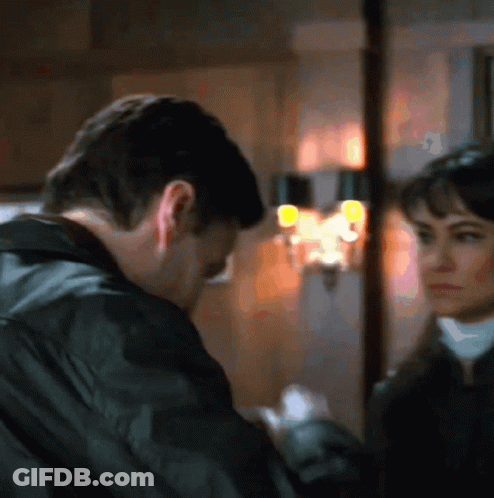 Man And Woman Looking At Each Other In Blurry Photo GIF