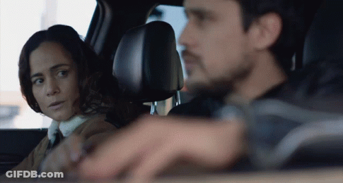 Man And Woman Looking At Each Other In Car GIF