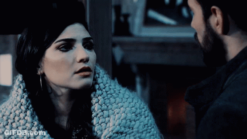 Man And Woman Looking At Each Other In Dark GIF