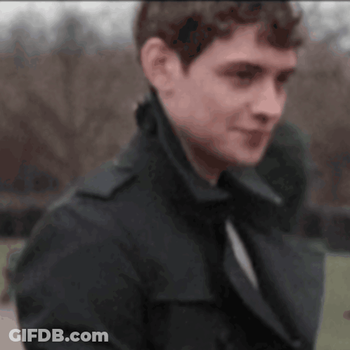 Man And Woman Looking At Each Other In Front Of Waterfall GIF
