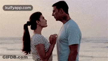 Man And Woman Looking At Each Other On Beach GIF