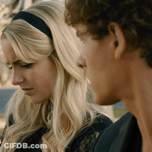 Man And Woman Looking At Each Other With Black Headband GIF
