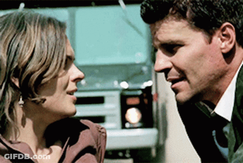 Man And Woman Looking At Each Other With Truck GIF