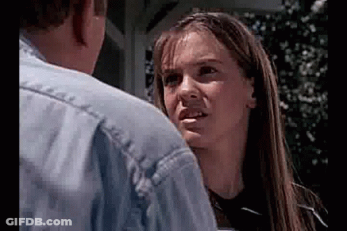 Man And Woman Looking At Each Other, Woman Making Funny Face GIF