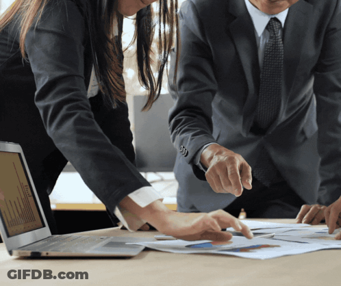 Man And Woman Looking At Laptop And Papers GIF