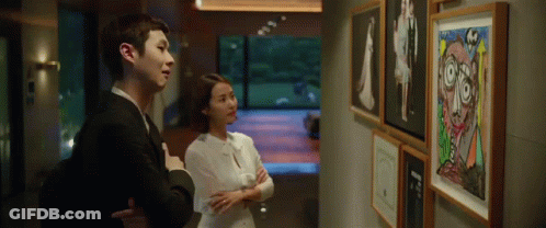 Man And Woman Looking At Painting GIF