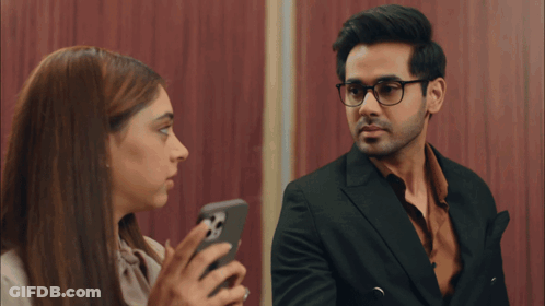 Man And Woman Looking At Phone GIF