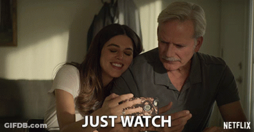 Man And Woman Looking At Phone Netflix Ad GIF