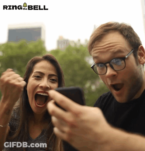 Man And Woman Looking At Phone Ring The Bell GIF