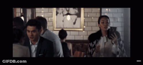 Man And Woman Looking At Phones In Restaurant GIF