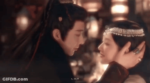 Man And Woman Looking Into Each Other's Eyes In Dark Room GIF