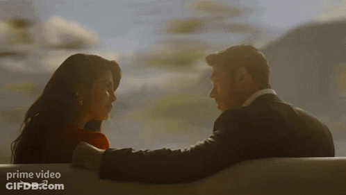 Man And Woman Looking Into Each Other's Eyes With Prime Video Logo GIF