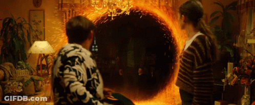 Man And Woman Looking Into Fire Portal GIF