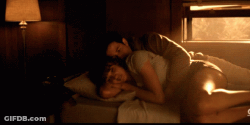 Man And Woman Lying On Bed With C GIF