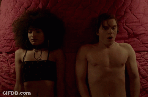 Man And Woman Lying On Bed With Red Blanket GIF