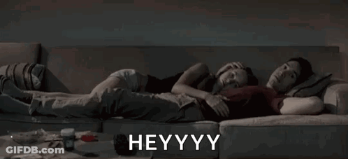 Man And Woman Lying On Couch Heyyy GIF