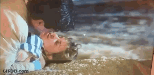Man And Woman Lying On Ground Heads Together GIF