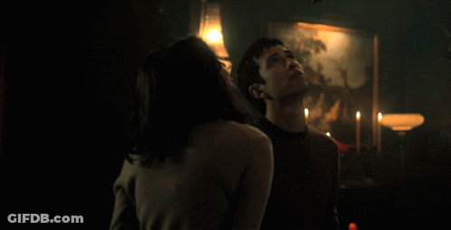 Man And Woman Making Eye Contact Red Curtain GIF
