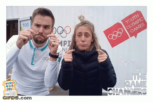 Man And Woman Making Funny Faces At Youth Olympic Games Sign GIF