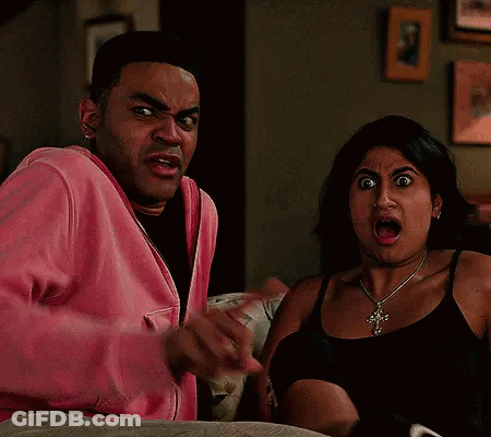 Man And Woman Making Funny Faces On Couch GIF