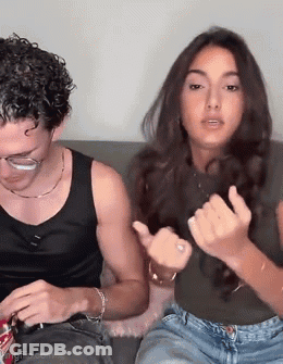 Man And Woman Making Funny Faces On Couch GIF