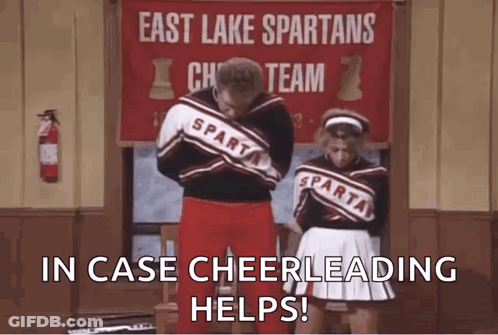 Man And Woman Next To East Lake Spartans Cheer Sign GIF