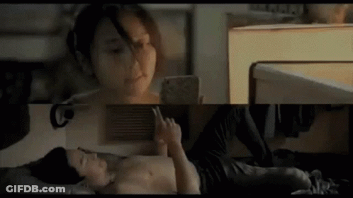Man And Woman On Bed Woman On Phone GIF
